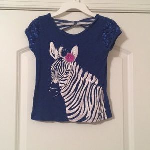 Sparkly blue shirt with zebra and bow on the back.